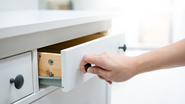 hand opening white drawer