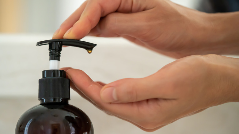 woman using liquid hand soap