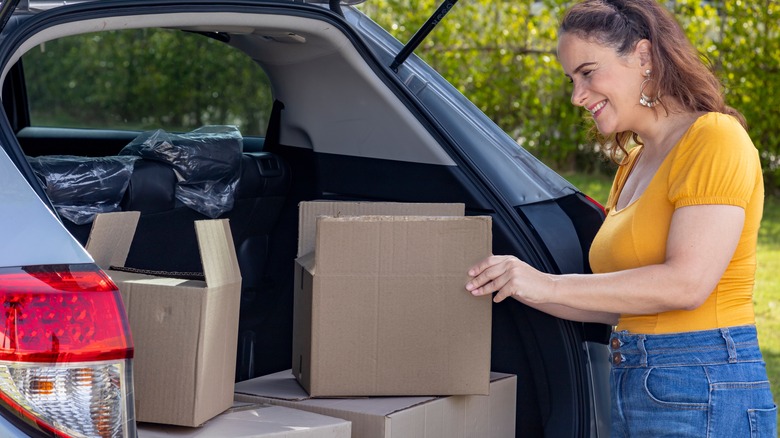 Woman loading haul in trunk