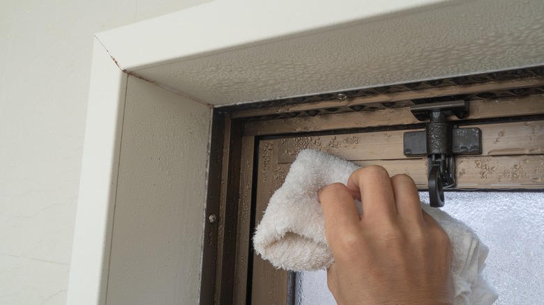 Hand wiping a window frame