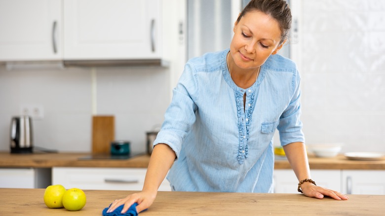 Woman wiping down a counter