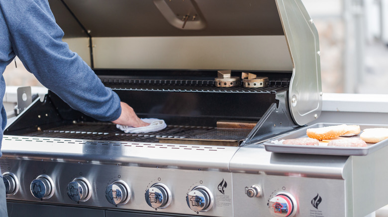 Person cleaning a grill grate