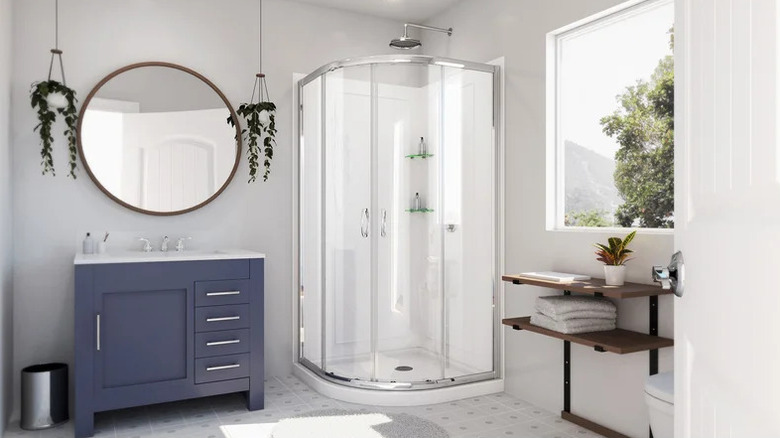 Bathroom with a circular sink and rounded shower