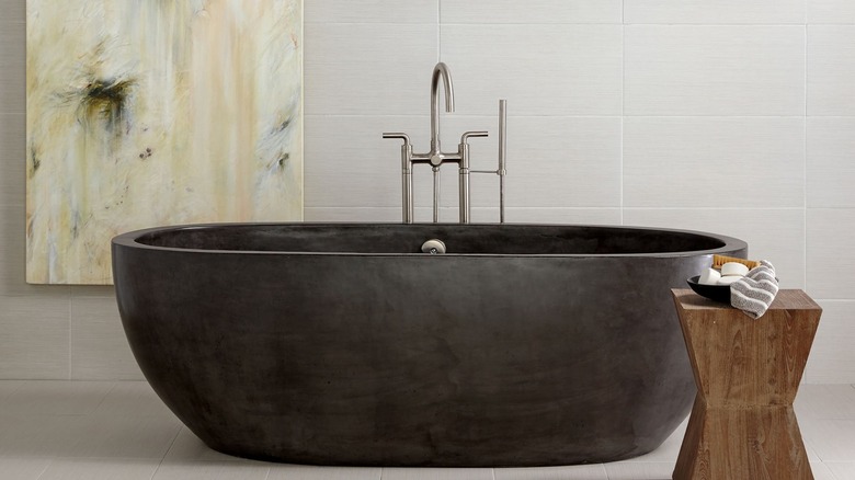 Pottery Barn Holas Handcrafted Freestanding Concrete Bathtub in modern bathroom