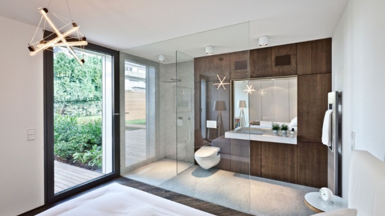 Bathroom with see-through smart glass wall