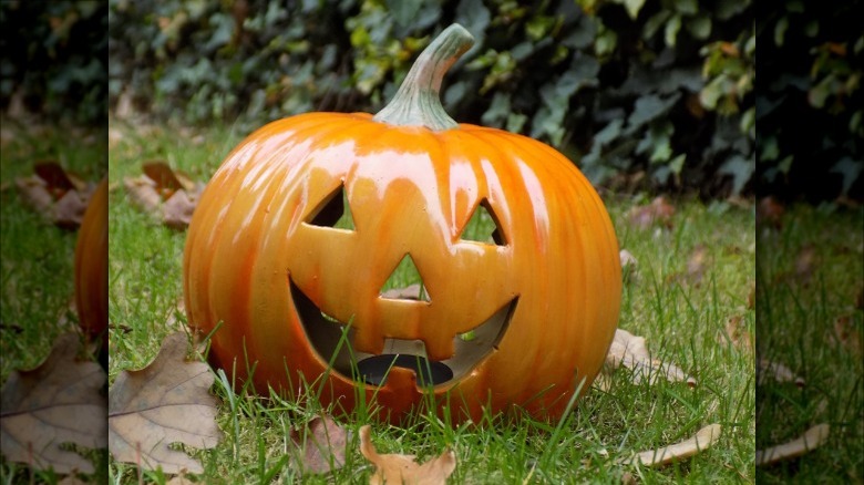 ceramic pumpkin in grass