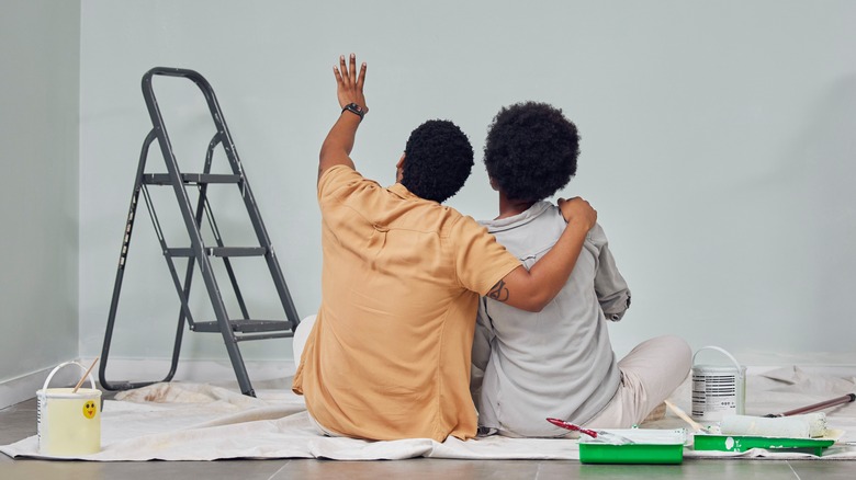 couple looking at blank wall