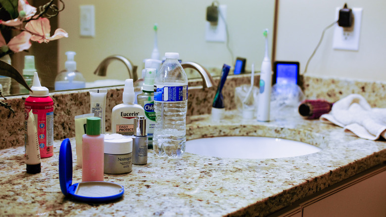 Cluttered bathroom sink and countertop