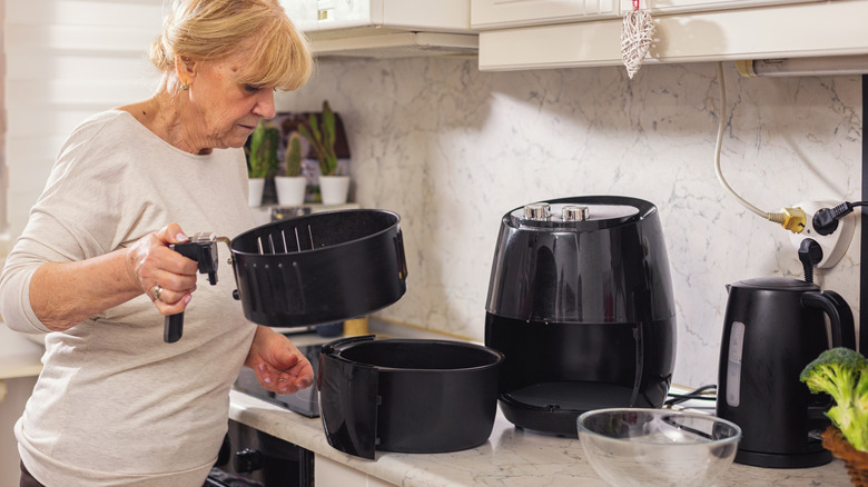 A woman using an air fryer