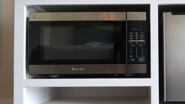 Magic Chef microwave in a white cabinet