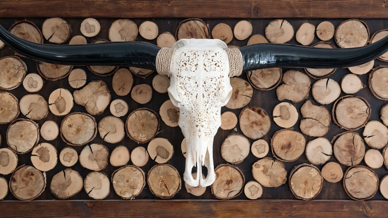 carved cow skull log wall