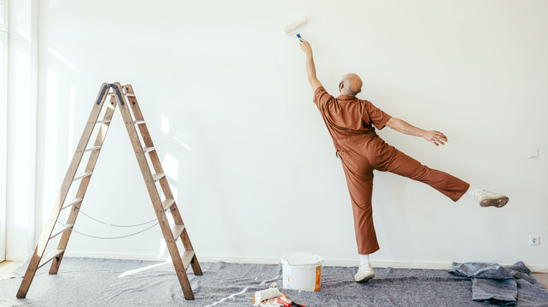 man painting wall