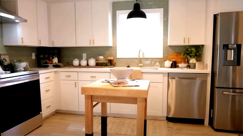 green kitchen backsplash and white cabinets