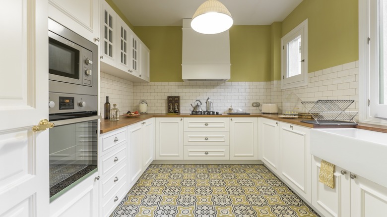 Green kitchen with tile floor and backsplash