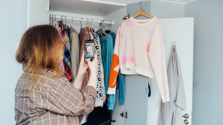 woman photographing sweater 