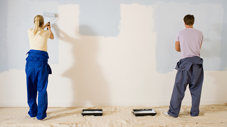 couple painting a wall