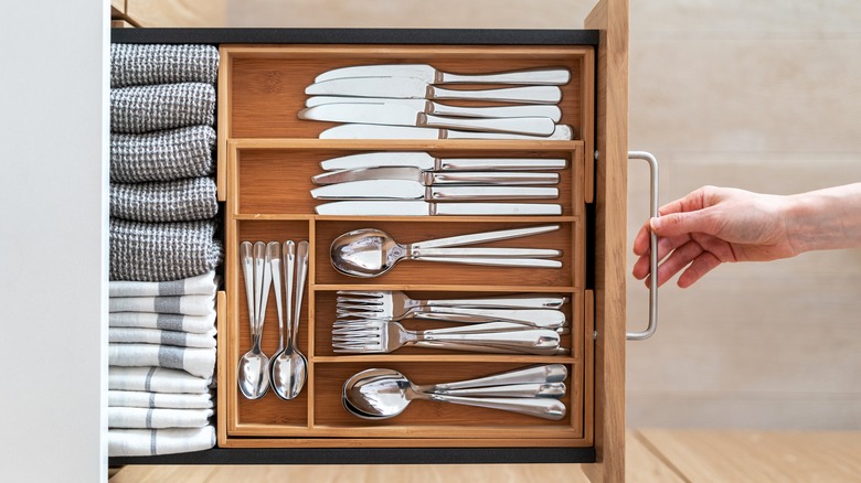 Person opening silverware drawer