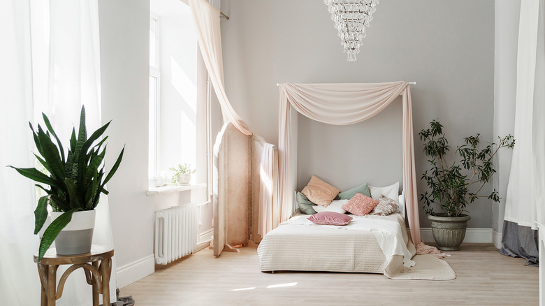 Bed with pink curtain headboard