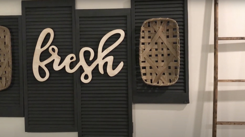 Old louvered closet doors transformed into a wall mounted art display.