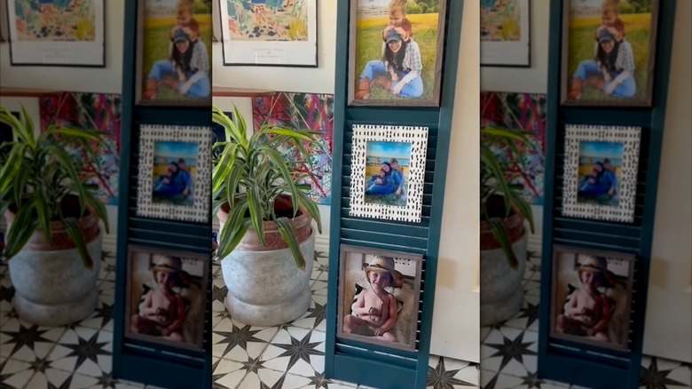 Old louvered closet doors transformed into a photo frame gallery that leans against the wall.