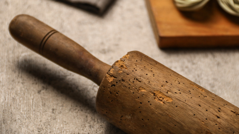 close up photo of an old wood rolling pin