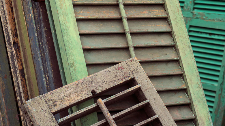 Stack of old window shutters leaning against each other