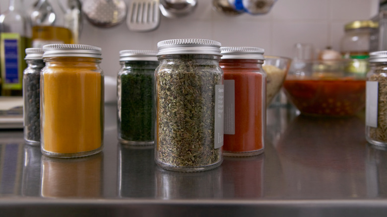 Spices in glass containers on a countertop