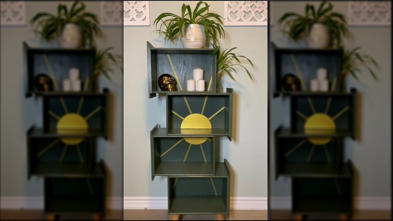 This four-shelf unit made from drawers is decorated with a gold sun accent.