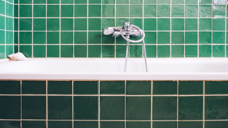 Various shades of green tile in bathroom