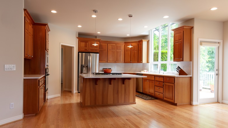 Kitchen with oak cabinets and ample wall space for painting