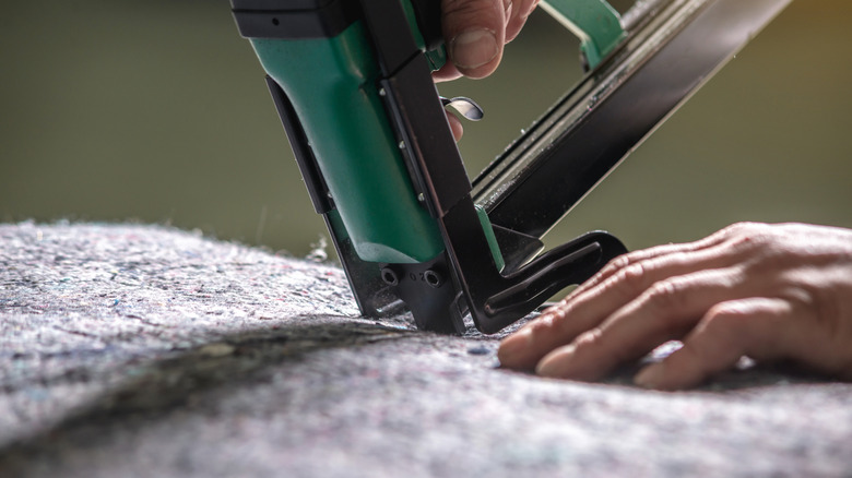 Close-up of a staple gun and batting.