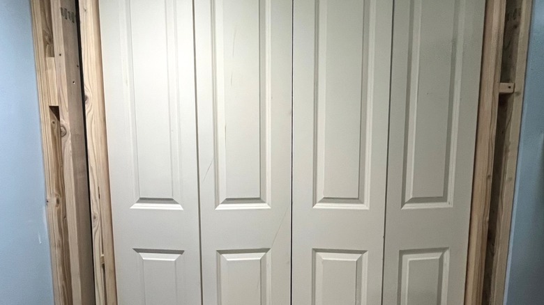 White bifold closet doors with exposed framing