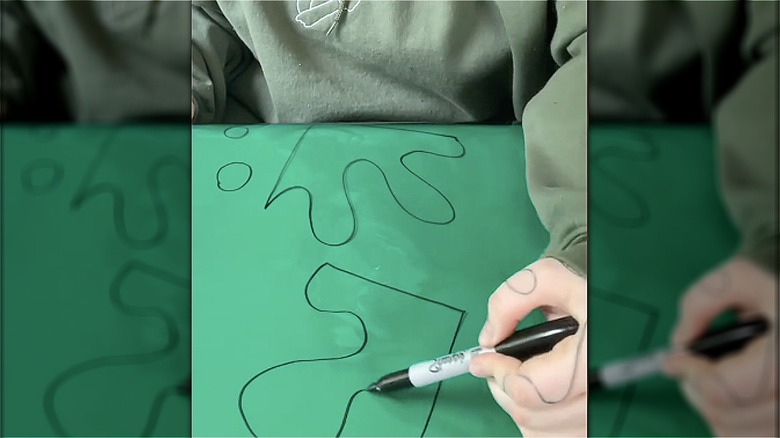 woman draws on colored gel