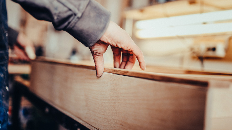 person working on drawer front