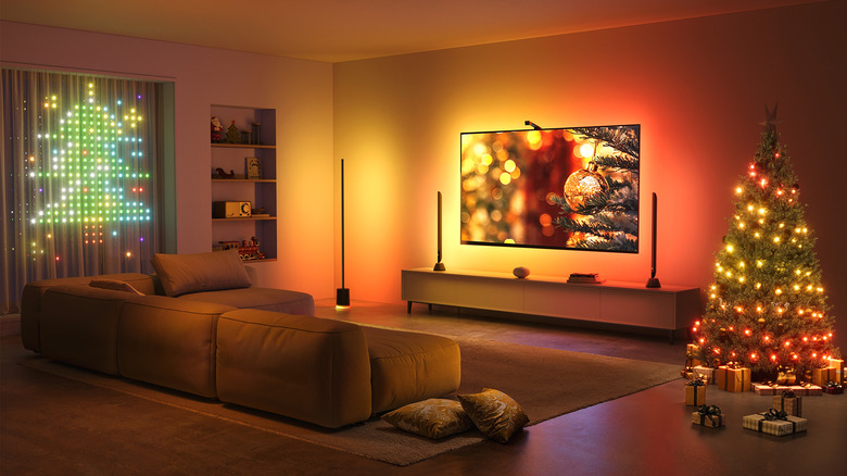 Living room with Christmas tree illuminated in warm hues by Govee floor lamps