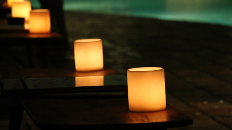 LED candles lined up close to a pool