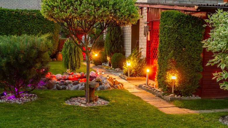 An illuminated outdoor pathway alongside a house