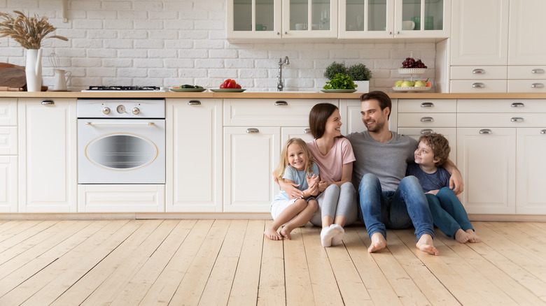 family sitting on kitchen floor