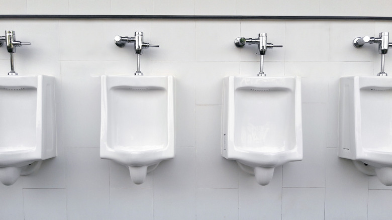 set of urinals in bathroom