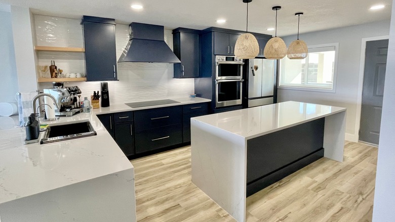 A kitchen with blue cabinetry