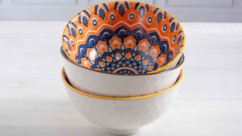 stack of three ceramic bowls painted with folk art patterns