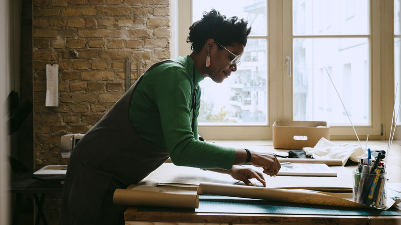 A woman works on a crafting project.