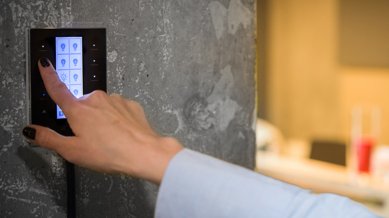 woman operating digital light switch