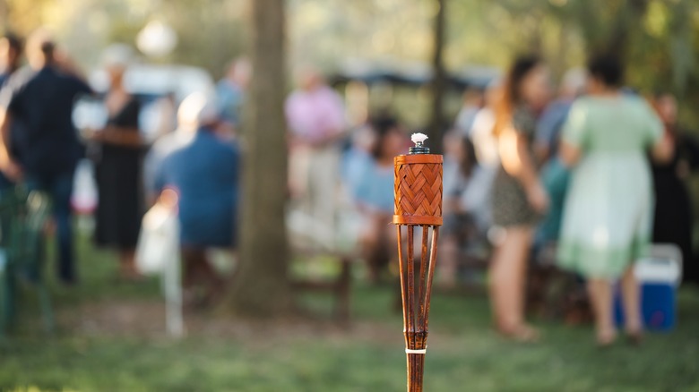 Tiki torch at outdoor gathering