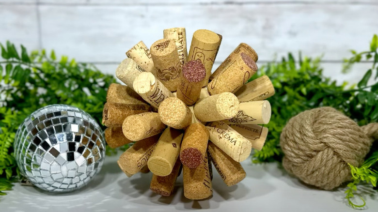 a wine cork ball sitting next to a disco ball