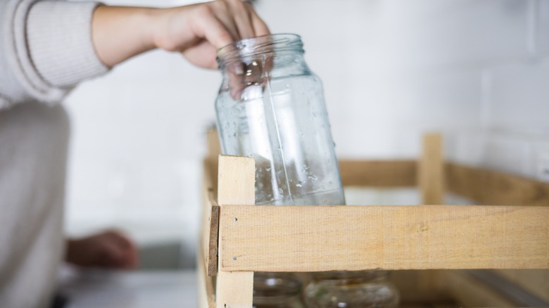 person holding empty jar