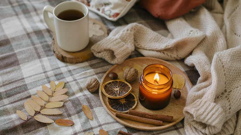 candle, sweater, and coffee cup