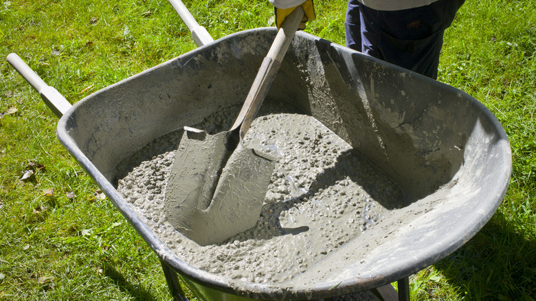 Man mixing concrete in wheelbarrow