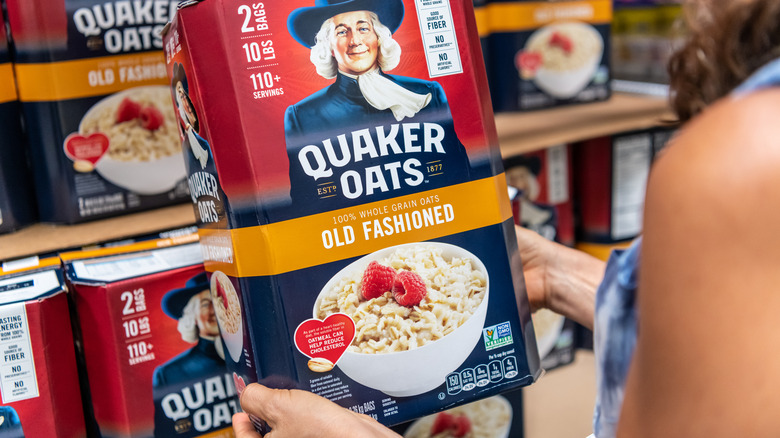 woman holds oatmeal box