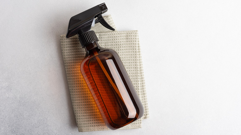 Amber colored bottle on top of cloth